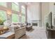 Bright living room features soaring ceilings, large windows, a cozy fireplace, and neutral decor at 2693 Blairsden Nw Pl, Kennesaw, GA 30144