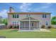Spacious backyard featuring a screened porch perfect for outdoor relaxation, complemented by lush green grass at 340 Aster Ridge Trl, Peachtree City, GA 30269