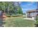 Beautifully landscaped backyard with a spacious screened porch and green lawn at 340 Aster Ridge Trl, Peachtree City, GA 30269