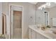 Bathroom with double vanity, shower/tub combo, and open doorway at 340 Aster Ridge Trl, Peachtree City, GA 30269