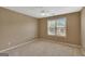 Bedroom with neutral walls, carpet, a ceiling fan and large window at 340 Aster Ridge Trl, Peachtree City, GA 30269