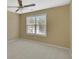 Bedroom with neutral walls, carpet, a ceiling fan and large window at 340 Aster Ridge Trl, Peachtree City, GA 30269