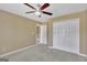 Neutral bedroom features a ceiling fan, carpet, and closet at 340 Aster Ridge Trl, Peachtree City, GA 30269