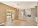 Bright dining area featuring a modern light fixture, wood floors, and French doors leading to an outdoor space at 340 Aster Ridge Trl, Peachtree City, GA 30269