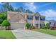 Classic brick exterior, 2-car garage, and manicured front yard at 340 Aster Ridge Trl, Peachtree City, GA 30269