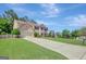 Charming brick home with a well-manicured lawn and a long driveway at 340 Aster Ridge Trl, Peachtree City, GA 30269