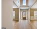 Inviting foyer with hardwood floors and abundant natural light streaming in from decorative front door at 340 Aster Ridge Trl, Peachtree City, GA 30269