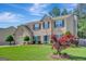 Beautiful two-story home with mature trees, green lawn and a vibrant Japanese maple accenting the front yard at 340 Aster Ridge Trl, Peachtree City, GA 30269