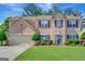 Charming brick two-story home with a well-manicured lawn and meticulously maintained landscaping at 340 Aster Ridge Trl, Peachtree City, GA 30269