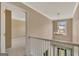 Bright hallway features neutral walls, white railing and trim, and a chandelier at 340 Aster Ridge Trl, Peachtree City, GA 30269