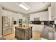 Modern kitchen with stainless steel appliances, granite counters, an island, and ample cabinet space at 340 Aster Ridge Trl, Peachtree City, GA 30269