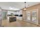 Bright kitchen featuring white cabinets, stainless appliances, and doors leading to the outdoor living area at 340 Aster Ridge Trl, Peachtree City, GA 30269