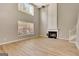 Sun-drenched living room with a soaring ceiling, fireplace, and large windows at 340 Aster Ridge Trl, Peachtree City, GA 30269