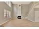 Light-filled living area features high ceilings, large windows, and a cozy fireplace at 340 Aster Ridge Trl, Peachtree City, GA 30269
