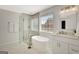 This bathroom includes a tub, shower, vanity with white cabinets, and a neutral color palette at 340 Aster Ridge Trl, Peachtree City, GA 30269