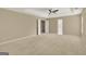 Spacious primary bedroom features neutral carpet, ceiling fan, and tray ceilings at 340 Aster Ridge Trl, Peachtree City, GA 30269