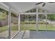 Screened-in porch with vaulted ceiling offering views of the manicured backyard at 340 Aster Ridge Trl, Peachtree City, GA 30269