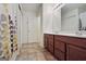 Bathroom with double sink vanity, tile floor, and shower and tub combination at 1560 Avalon Creek Rd, Sugar Hill, GA 30518