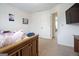 Bedroom with double door closet, TV, and neutral carpeting at 1560 Avalon Creek Rd, Sugar Hill, GA 30518