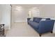 Spacious living room featuring a comfortable couch, neutral walls, and carpet flooring at 1560 Avalon Creek Rd, Sugar Hill, GA 30518