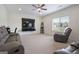 Spacious living room with a ceiling fan, plush seating, and a large window at 1560 Avalon Creek Rd, Sugar Hill, GA 30518