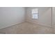 This bedroom features neutral walls and carpet, plus a window for natural light at 4003 Garden Ln, College Park, GA 30337