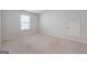 This bedroom features neutral walls and carpet, plus a window for natural light at 4003 Garden Ln, College Park, GA 30337