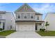 Charming two-story home featuring a two-car garage, manicured lawn, and inviting curb appeal at 4003 Garden Ln, College Park, GA 30337