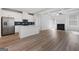 Modern open-concept kitchen with stainless steel appliances, island, and a seamless flow into the living area at 4003 Garden Ln, College Park, GA 30337
