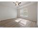 Spacious and bright bedroom with modern ceiling fan, large windows, and wood floors at 4003 Garden Ln, College Park, GA 30337