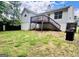 The backyard features a deck with stairs, a grill, and a partially grassy area at 1741 Portwest Way, Hampton, GA 30228