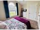 Bright bedroom with a large window, neutral walls, carpet, and colorful artwork at 1741 Portwest Way, Hampton, GA 30228