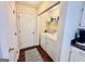 Functional laundry room with a washer, dryer, and storage shelves at 1741 Portwest Way, Hampton, GA 30228