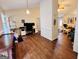 Open-concept living space with hardwood floors, a workspace, and comfortable furnishings at 1741 Portwest Way, Hampton, GA 30228