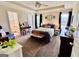 Spacious main bedroom features a tray ceiling, ceiling fan, and an en-suite bathroom at 1741 Portwest Way, Hampton, GA 30228