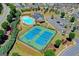Aerial view of community tennis courts, pool, clubhouse, and parking lot at 1369 Star Water Dr, Lawrenceville, GA 30045