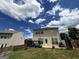 View of the home's backyard with a small deck and lush green grass at 1369 Star Water Dr, Lawrenceville, GA 30045