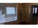 Bright bathroom featuring a soaking tub, glass shower, and neutral tile at 1369 Star Water Dr, Lawrenceville, GA 30045