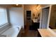 Bright bathroom features a soaking tub, a separate vanity, and an opening view to the main bedroom at 1369 Star Water Dr, Lawrenceville, GA 30045