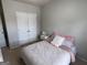 Neutral bedroom showcasing a plush bed and a large double door closet at 1369 Star Water Dr, Lawrenceville, GA 30045