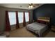 Large bedroom featuring three windows and a blue accent wall at 1369 Star Water Dr, Lawrenceville, GA 30045
