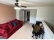 Open bonus room with a desk and a red sofa at 1369 Star Water Dr, Lawrenceville, GA 30045