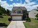 Exterior of a two-story home with brick and siding, a garage, and well-maintained lawn at 1369 Star Water Dr, Lawrenceville, GA 30045