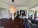 Open-concept foyer with dark hardwood floors, seamlessly connecting to the kitchen and living areas at 1369 Star Water Dr, Lawrenceville, GA 30045