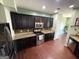 Modern kitchen featuring dark wood cabinets, granite countertops, and stainless steel appliances at 1369 Star Water Dr, Lawrenceville, GA 30045