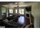 Open living room with a hardwood floor, fireplace, sectional sofa and an entry door to the back yard at 1369 Star Water Dr, Lawrenceville, GA 30045