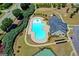 An aerial view of a community pool area with a clubhouse and lush greenery at 1369 Star Water Dr, Lawrenceville, GA 30045