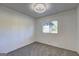 A clean and simple bedroom with a window offering natural light, and neutral carpet flooring at 50 Caroline Ave, Stockbridge, GA 30281