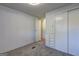 Bedroom featuring carpet flooring, an overhead light, and a built in closet and storage system at 50 Caroline Ave, Stockbridge, GA 30281