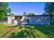 Exterior back of home with large yard and a patio area at 50 Caroline Ave, Stockbridge, GA 30281